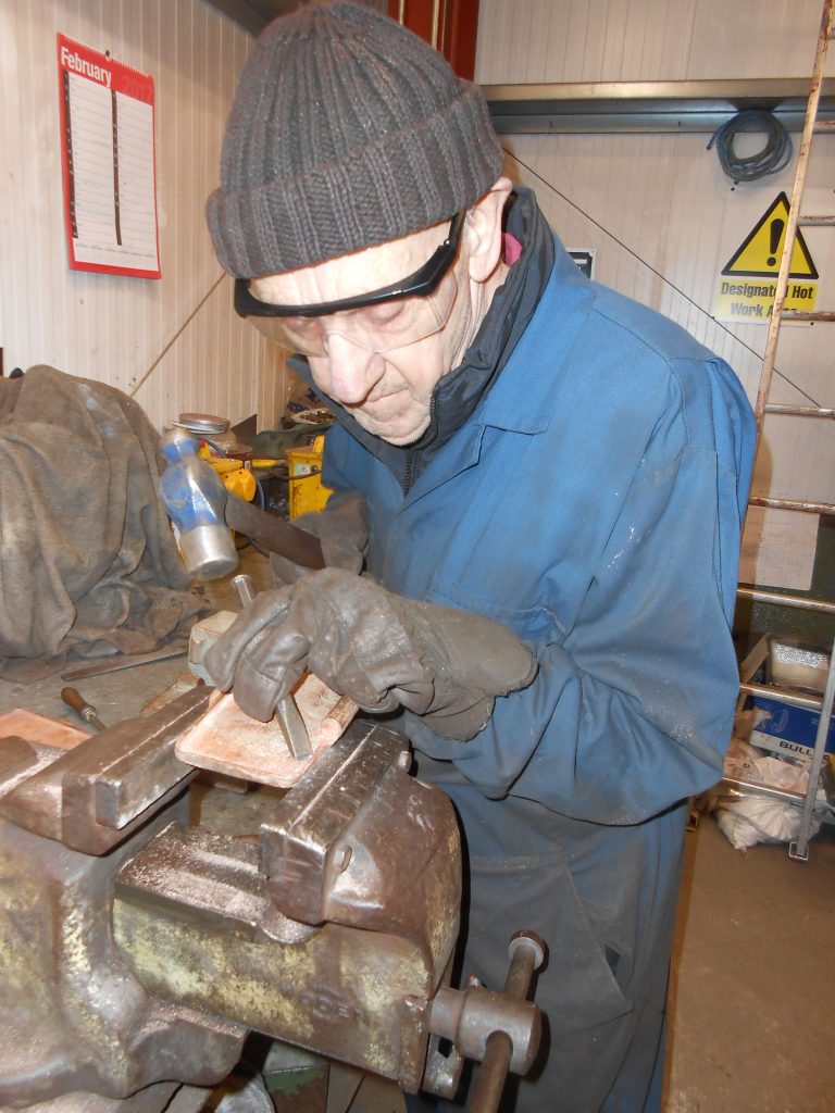 Howard cleaning up a lubrication pot lid