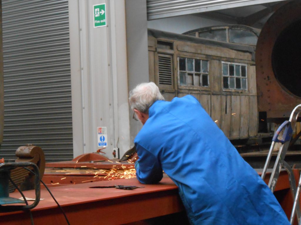 John Houghton grinding off weld on Caliban's running board