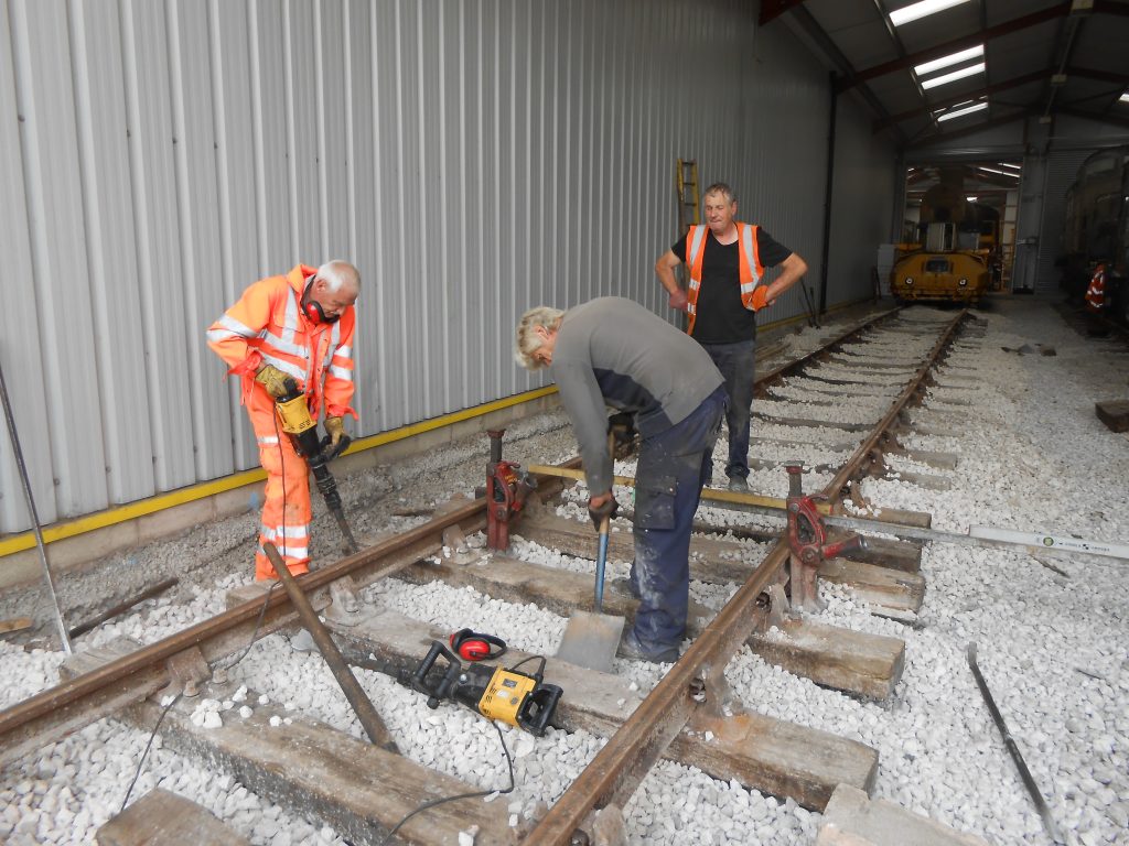 Ed Tatham, Phil Preston and Keith Brewer levelling track on road three of the shed