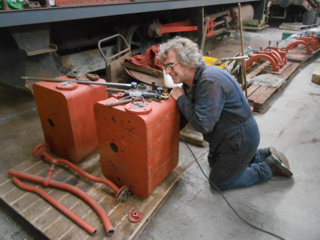 Adrian cleaning the inside of one of Caliban's sand boxes