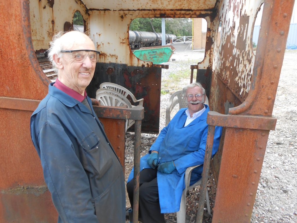 Howard with John H as he takes a break from cleaning Caliban's cab.