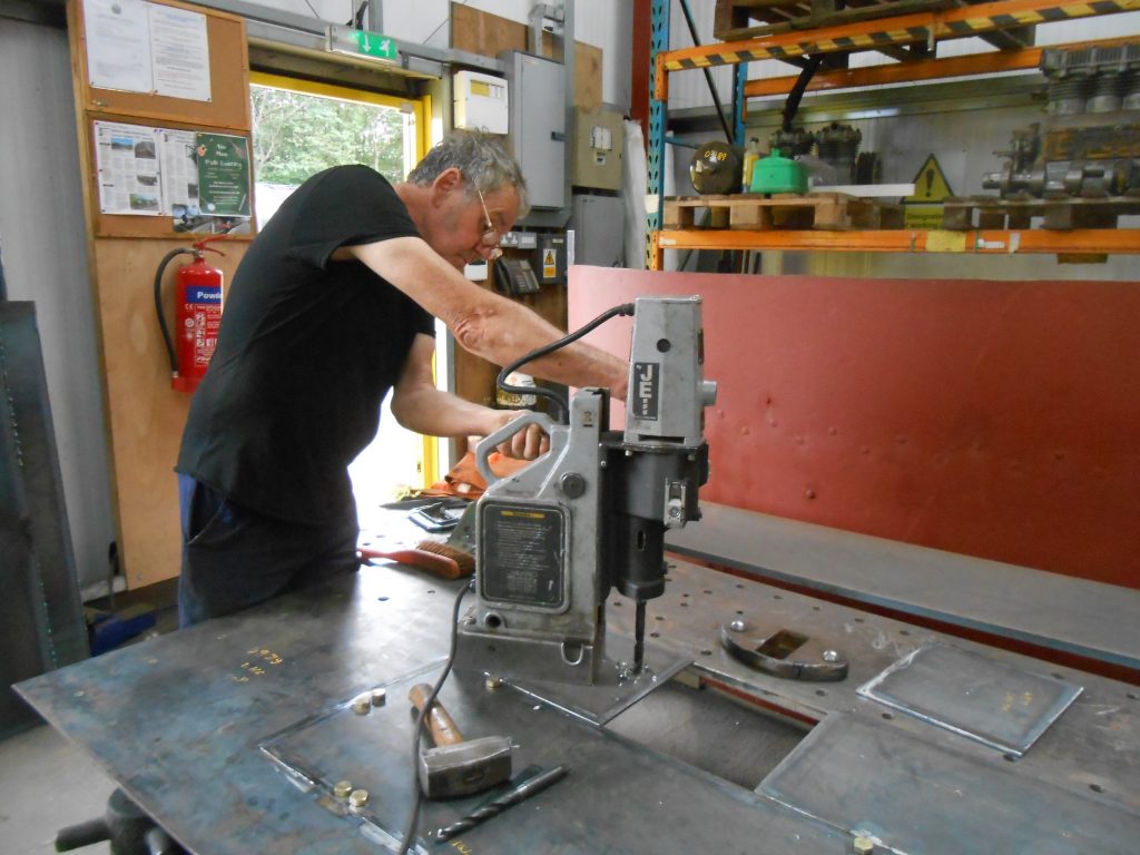 Keith drilling more holes in the new piece of running plate