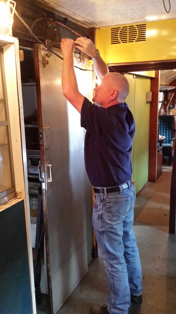 Paul re-installs the buffet counter door