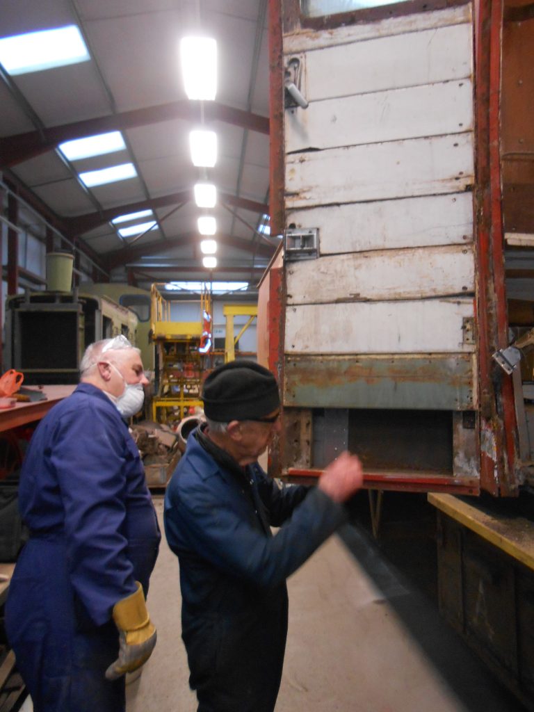 John Davis and Howard Fletcher inspect the RSR's TPO door which requires corrosion repairs