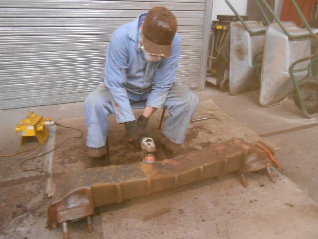 Fred fills the shed with dust as he cleans 5643's superheater header.