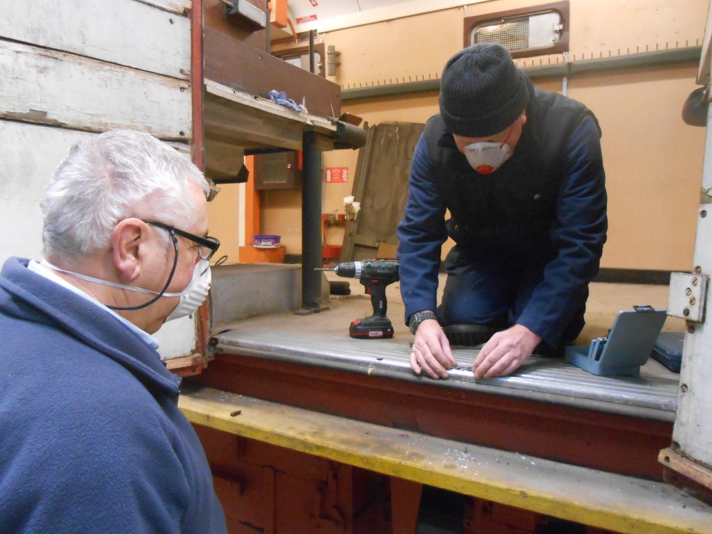 John Davis and Paul working on the TPO's double doors