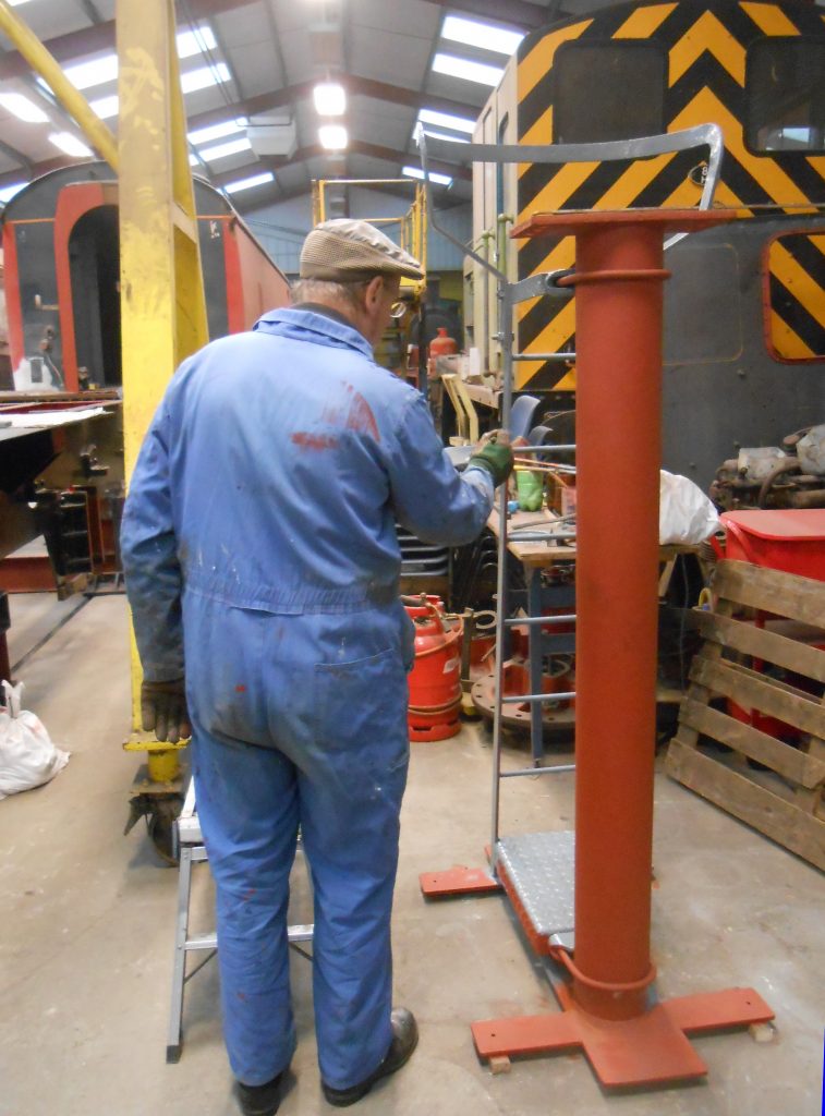 David applies paint to a signal post that will be going in the RSR Museum