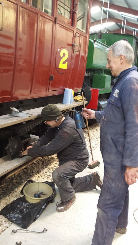 Ade examines one of the NLR axle pads - and is Tim oiling Ade's ear or holding the brush?t