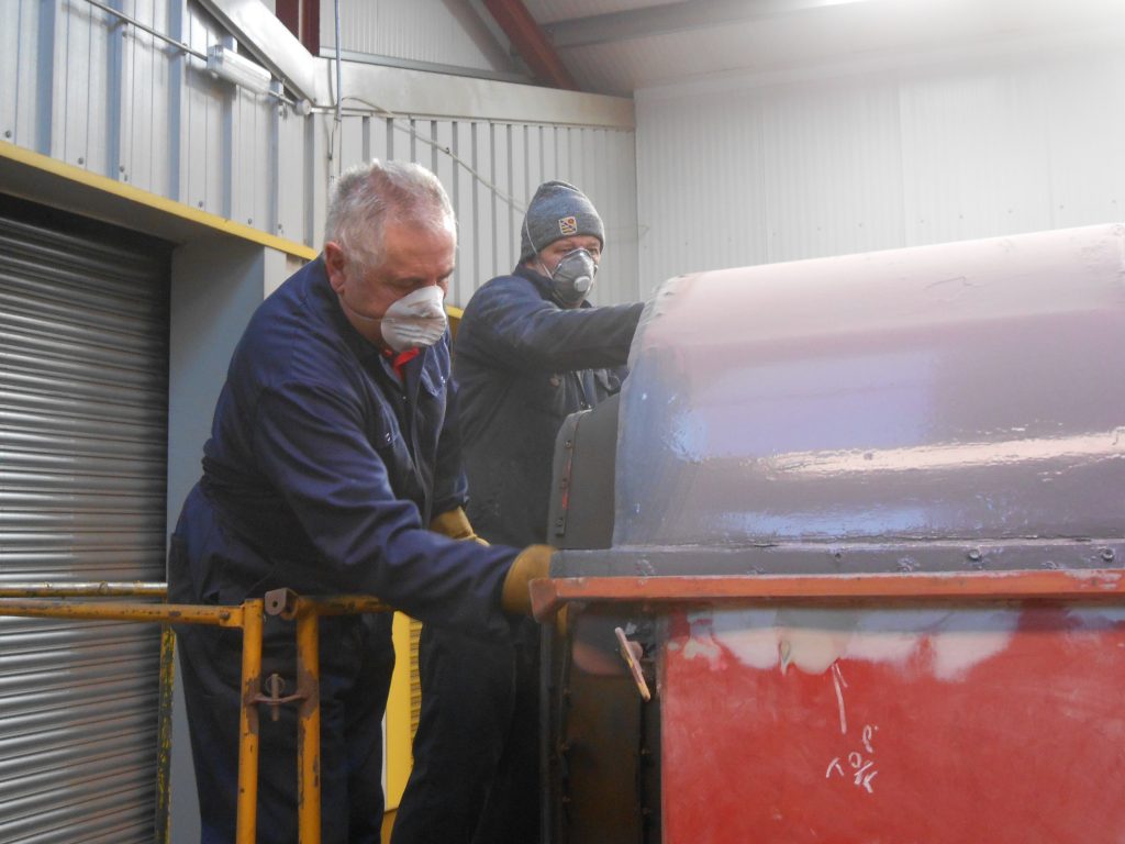 John David and Mike Rigg preparing a corridor end f the TPO for painting