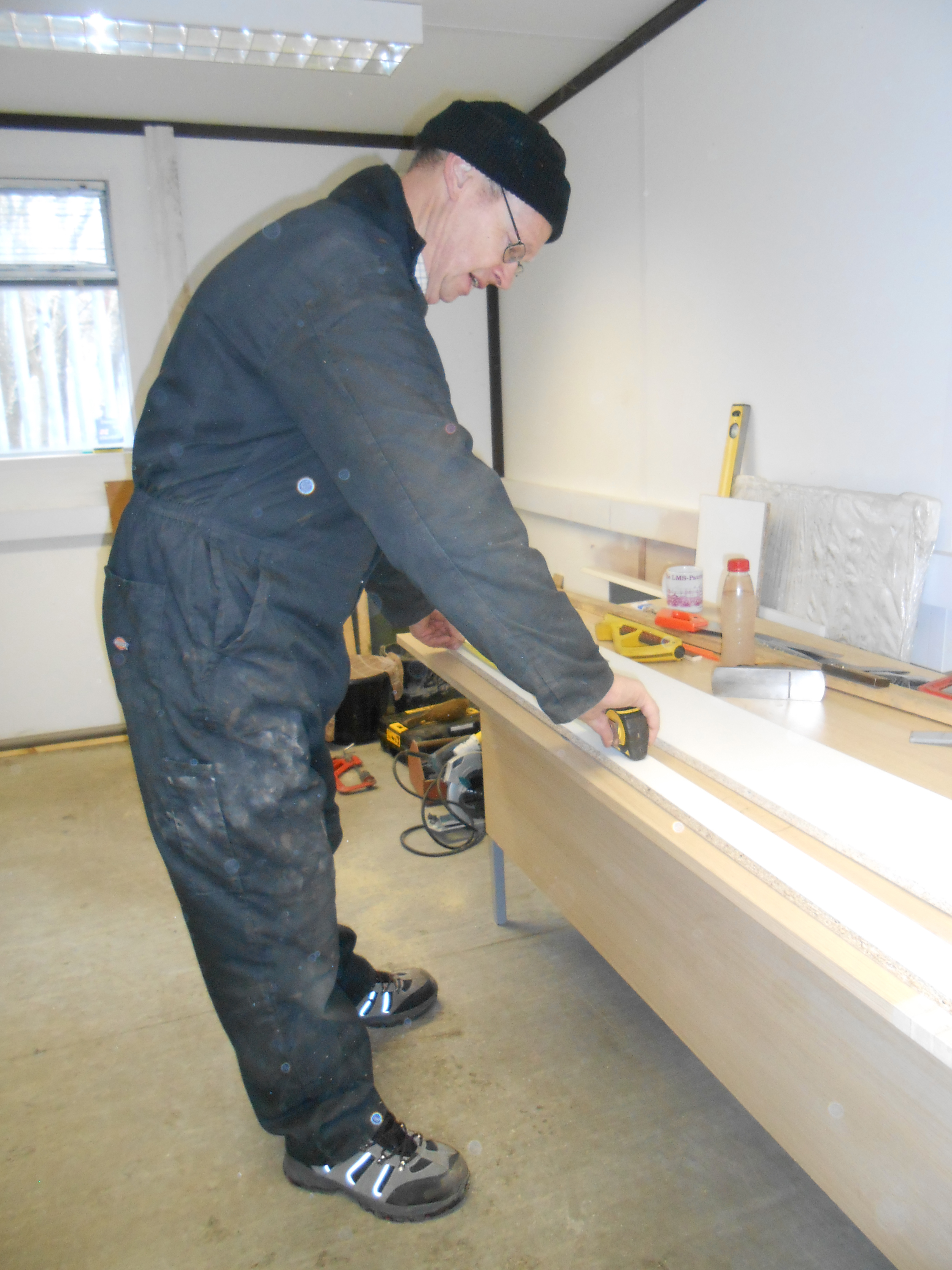 John Dixon measure up the cupboard bottom fascia board