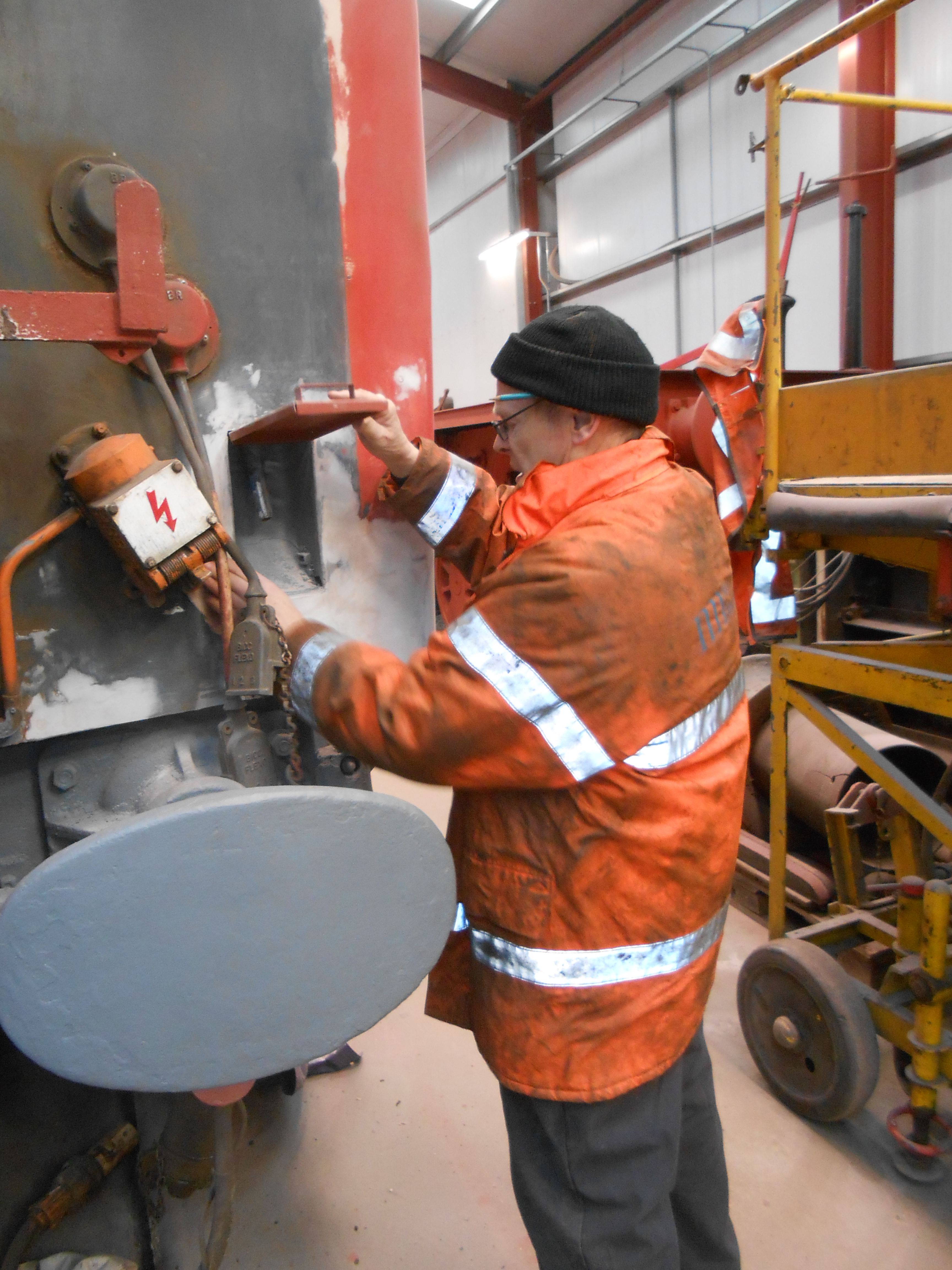 John Dixon preparing the west end of the TPO coach for painting