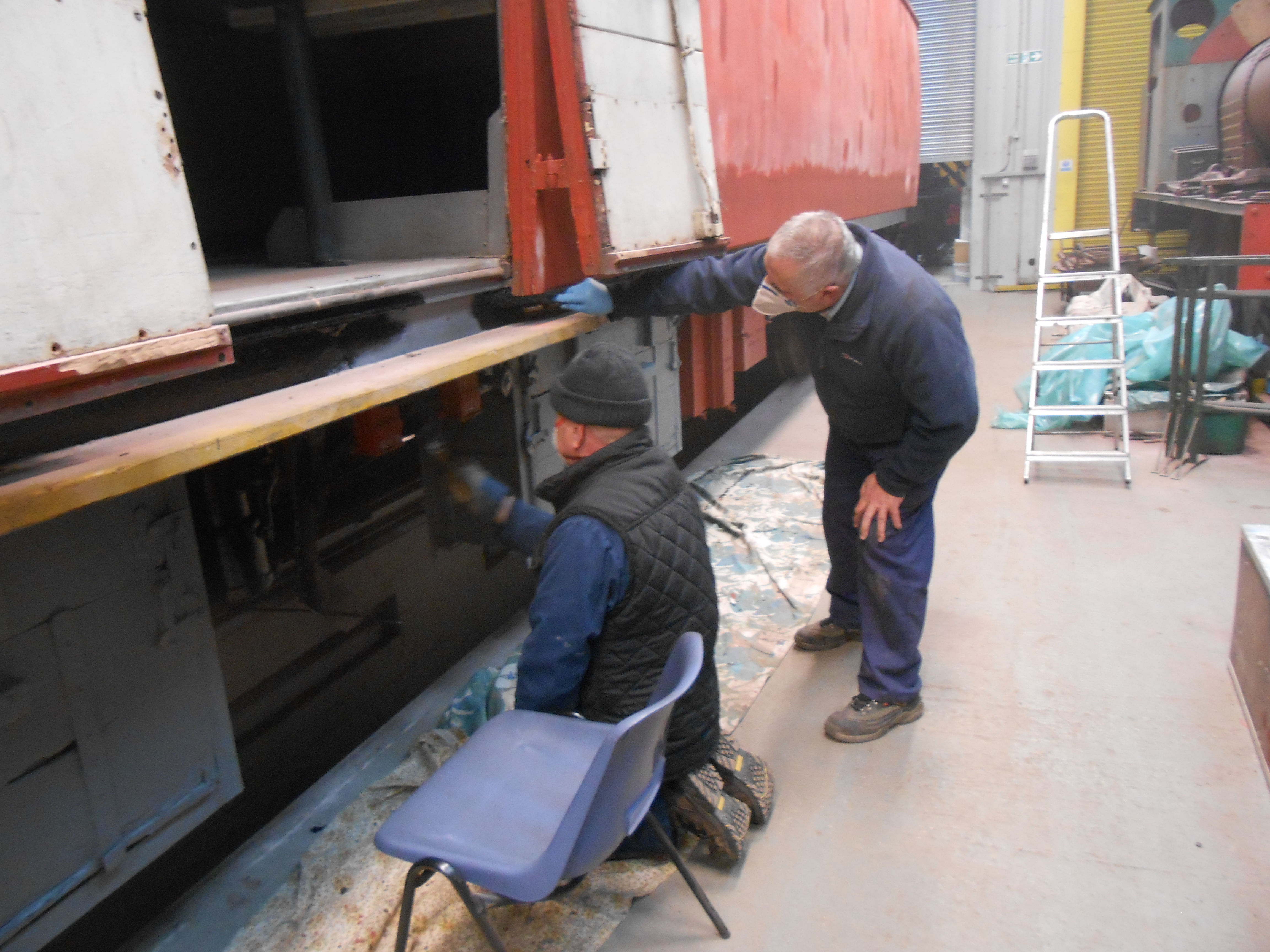 Paul Newton and John Davis at work painting the TPO coach