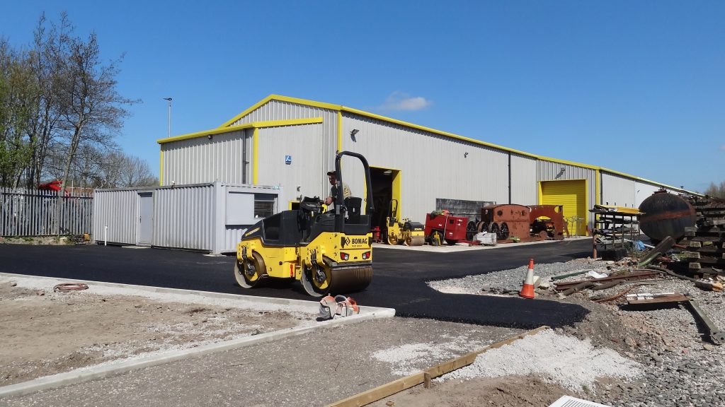 Laying tarmac outside the FRT shed. 200418