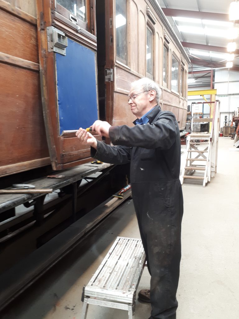 John Dixon re-assembling a door after repairing a crack in the front teak panel