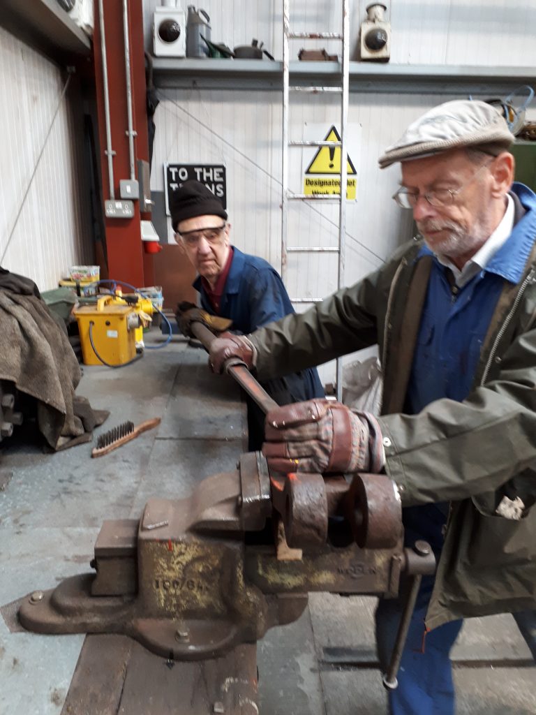 Howard and David with a spring hanger screw to remove