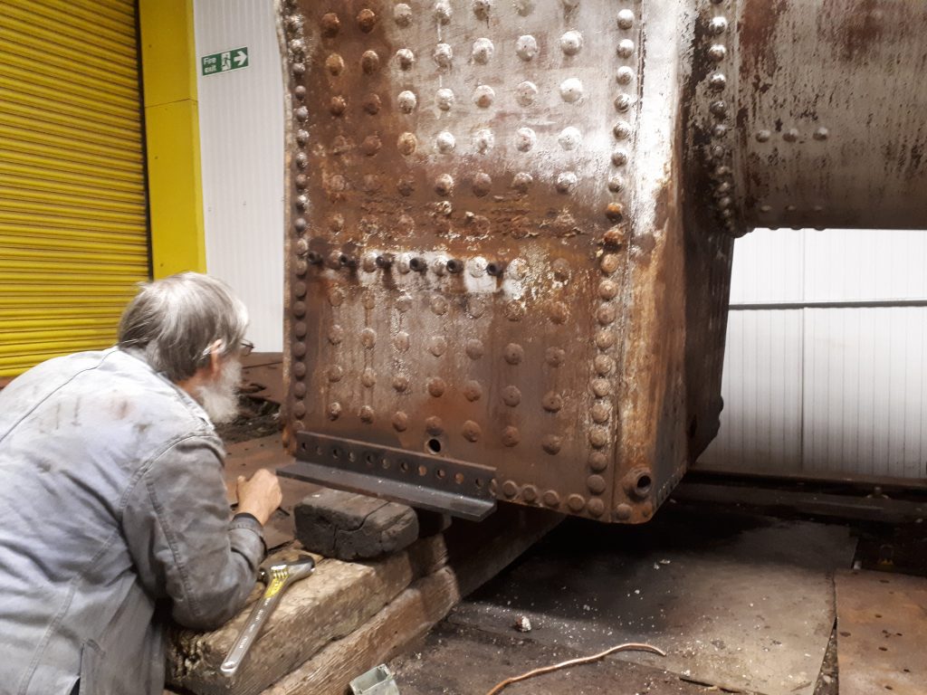 Alan Middleton inspects the outside on FR 20's firebox