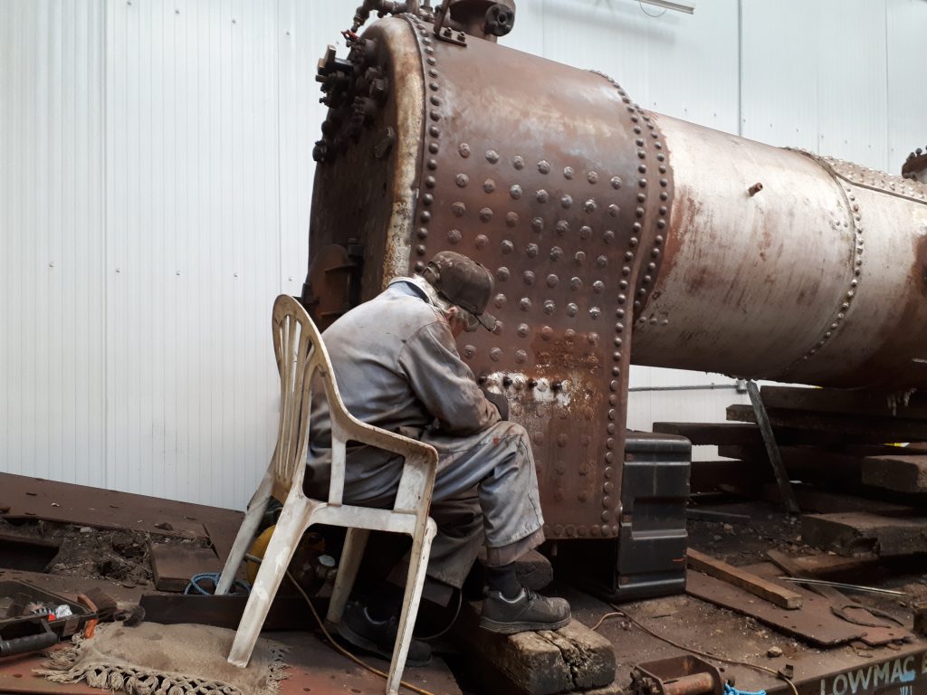 Fred cleans the outside of FR 20's firebox