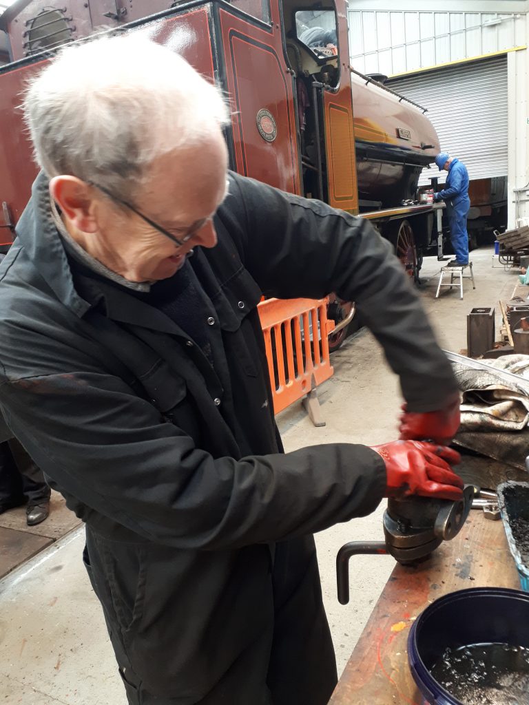 John Dixon gives one of the water valves a good clean