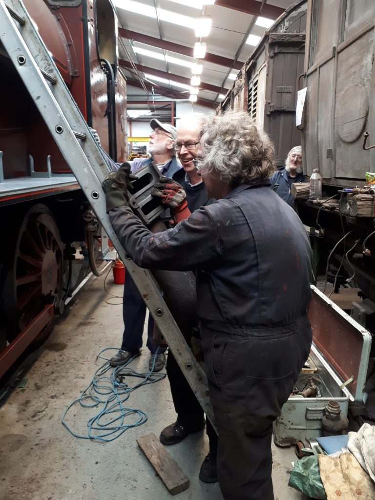 Ade and John Dixon propel Cumbria's 'J 'pipe up a ladder whilst Phil Bell hauls on the safety rope and Alan watches on in the background