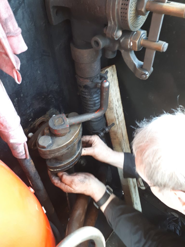 John Dixon fits the drivers side water valve on Cumbria