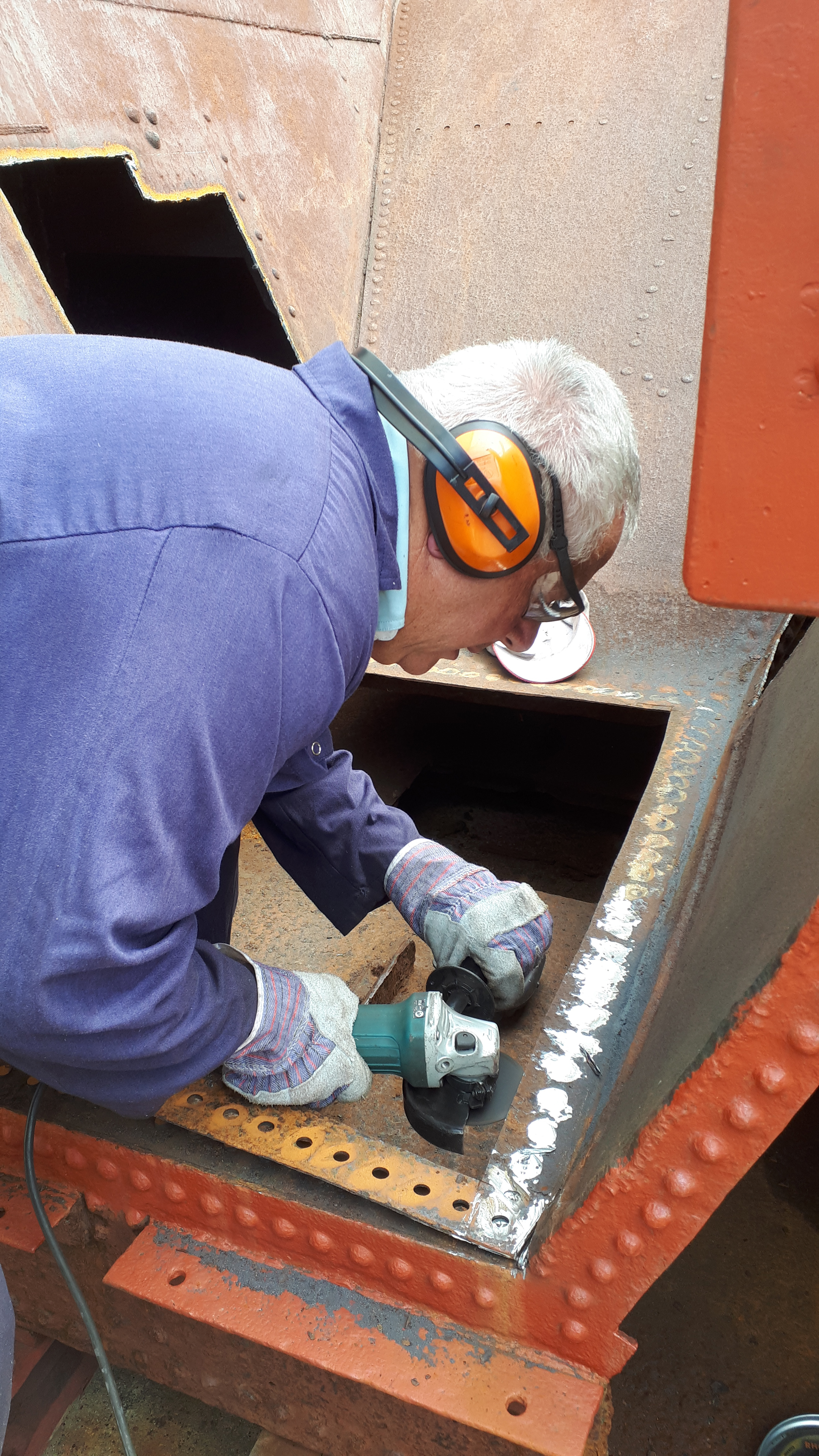 John Davis removes rivets from Wootton Hall's tender tank.