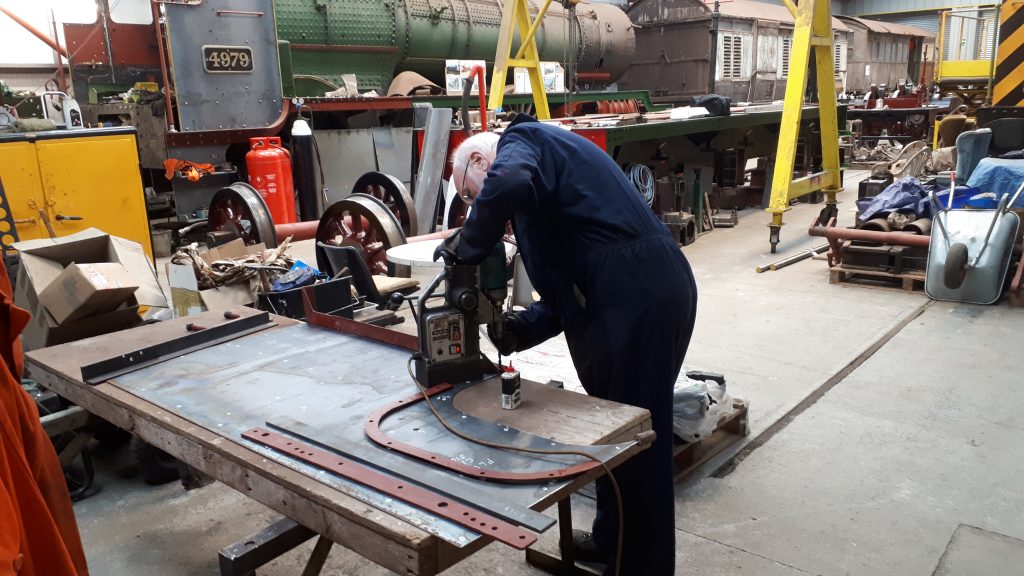 Phil Bell drilling holes in one of Fluff's new cab sides