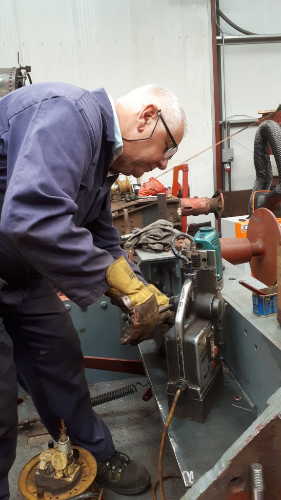 John Davis drilling holes in Fluff's new frame stretcher