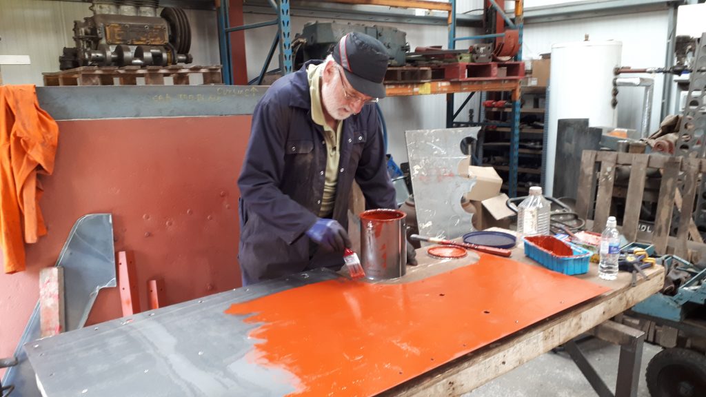 Phil Bell painting one of Fluff's cabs sides