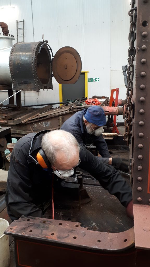 John Dixon and Roger cleaning the front drag box on FR 20's tender