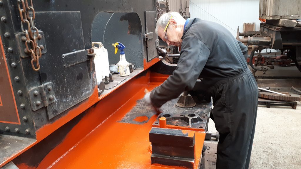 John Dixon applies a coat of primer to FR 20's front tender drag box