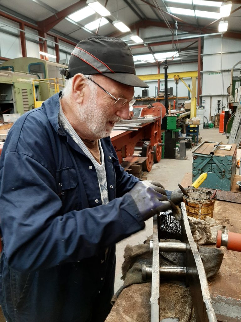 Phil Bell cleaning one of FR 20's tender brake hangers