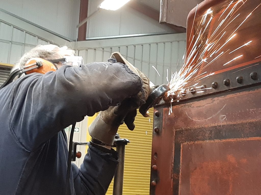 John Dixon cleans up the new rivet heads on Fr 20's tender