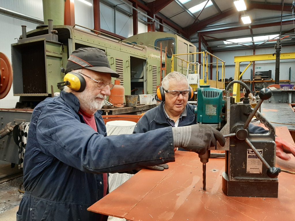 Phil Bell and John Davis drilling holes in Fluff's running board