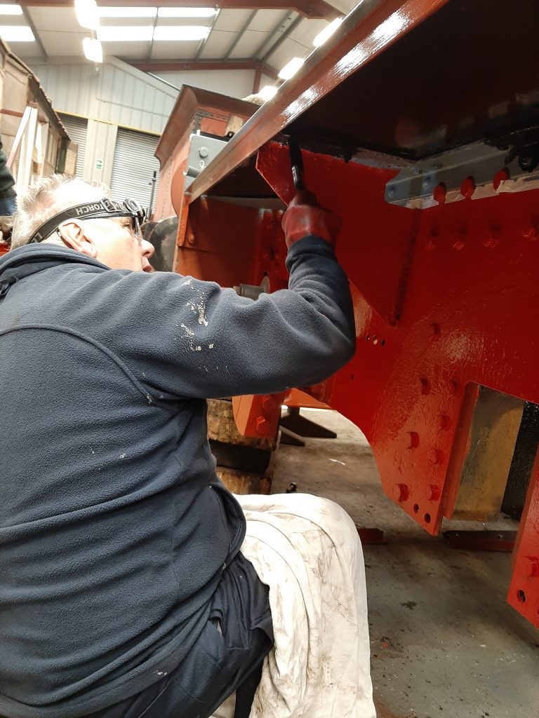 John Davis painting the underside of Fluff