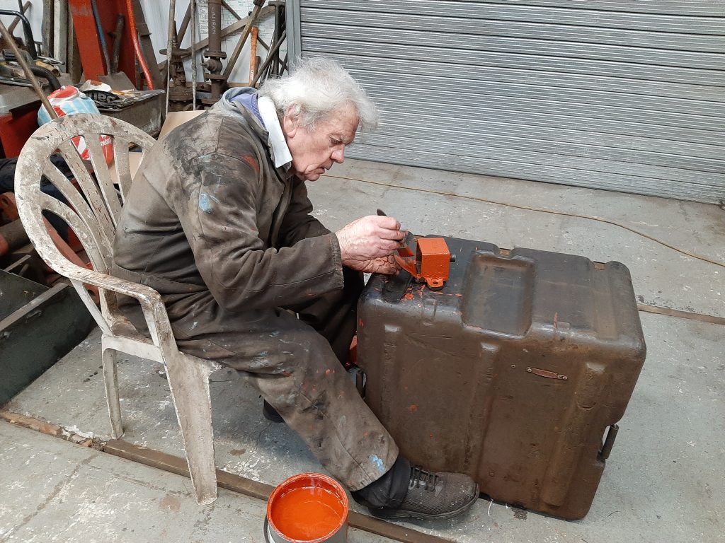 Fred paints one of Fluff's lubrication pots