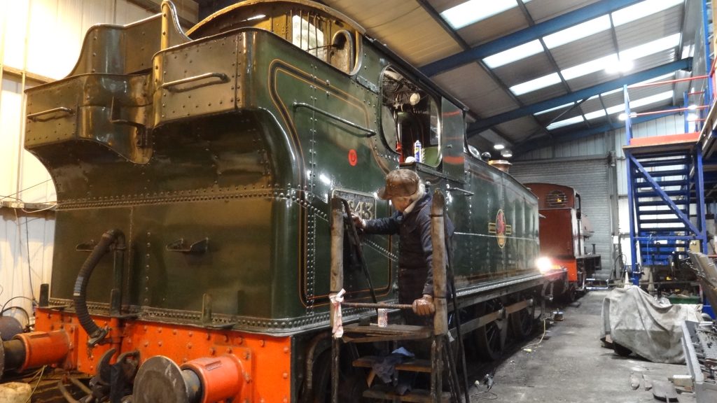 Fred cleans one of 5643's brass number plates