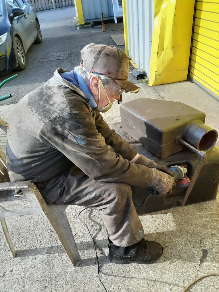 Fred cleaning up one of Fluff's sand boxes