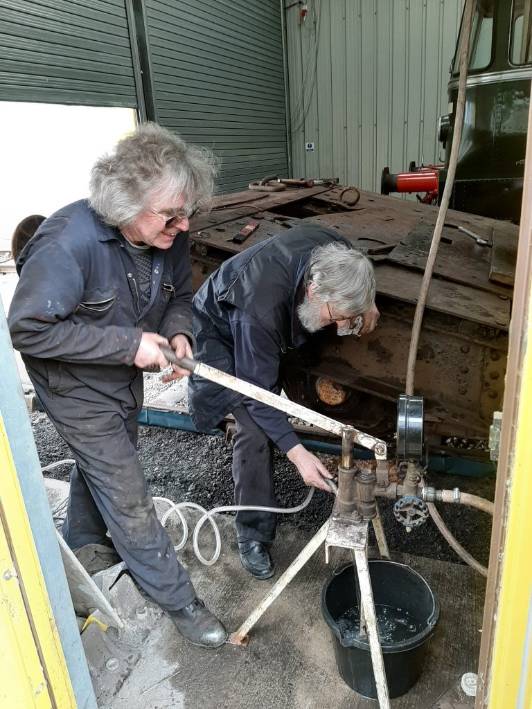 Ade raises pressure on FR 20's boiler whilst Alan tops up the water bucket