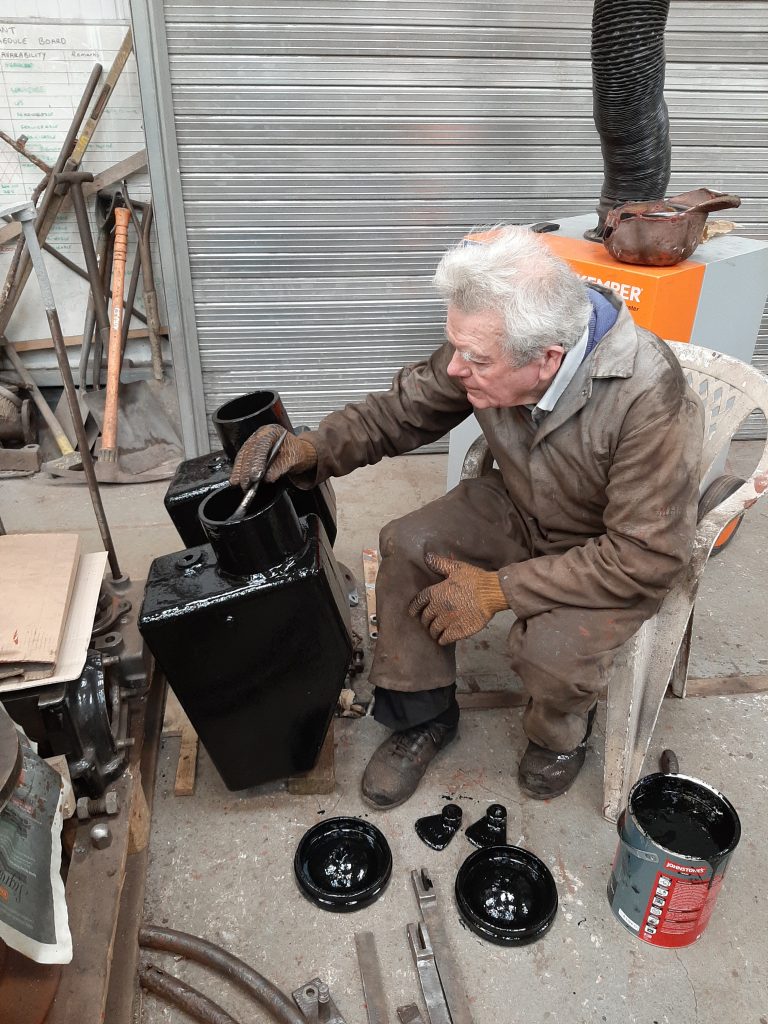 Fred paints Fluff's sand boxes