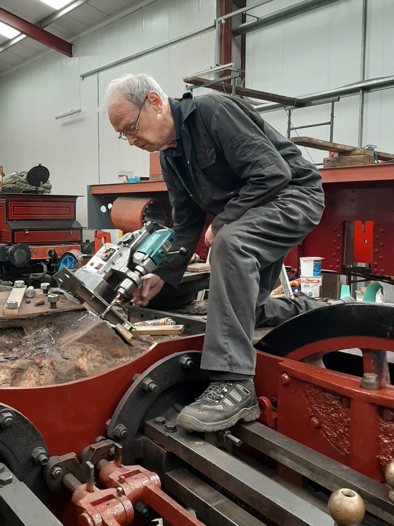 John Dixon drilling out steam pipe studs