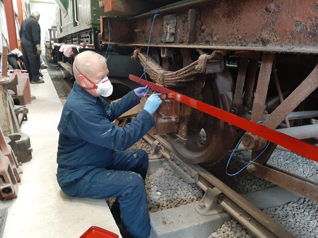 Paul Newton painting the bench seat slats