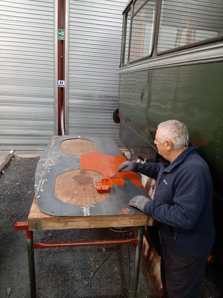 John Davis painting Fluff's cab spectacle plate