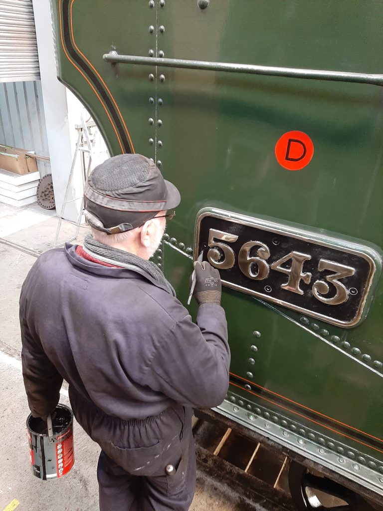 Phil touches up the black paintwork on 5643's brass numberplates