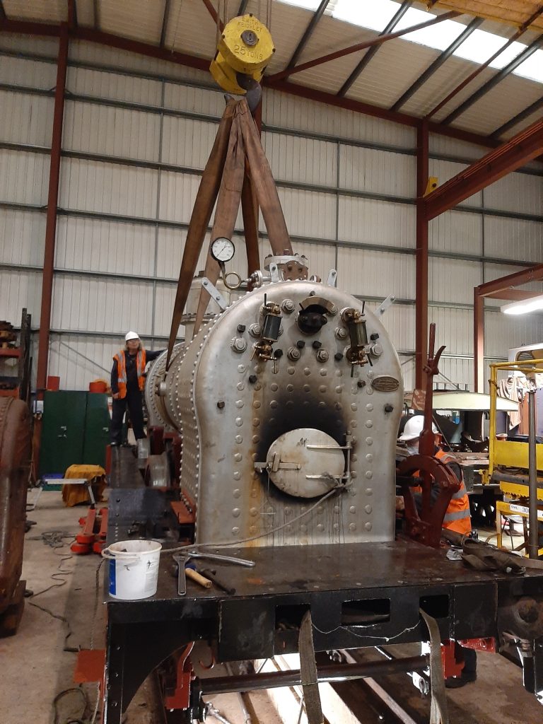 The boiler being lowered into the frames