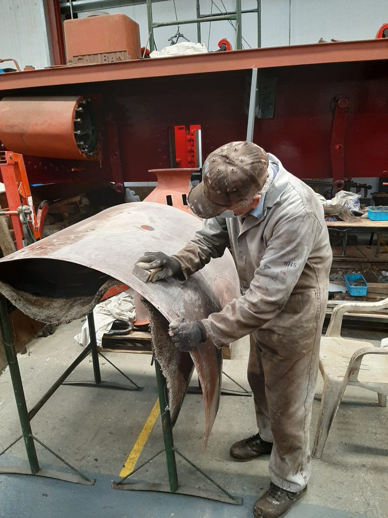 Fred rubbing down the first of FR 20's cladding sheetsl