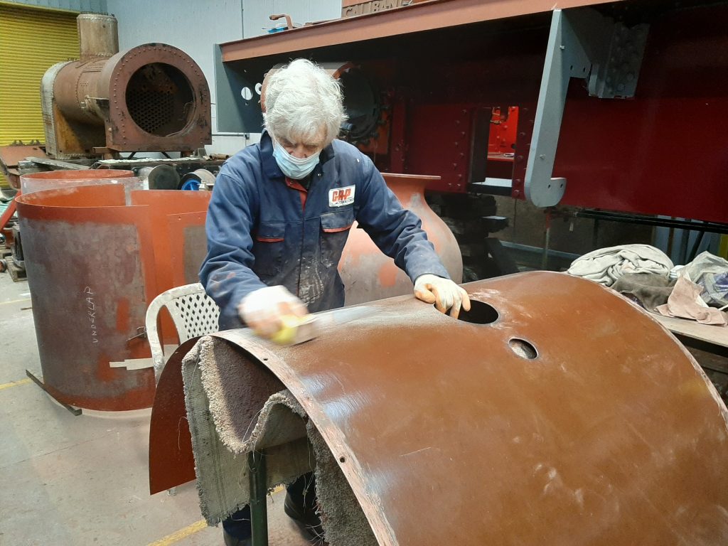 Ed Tatham sanding FR 20's boiler cladding