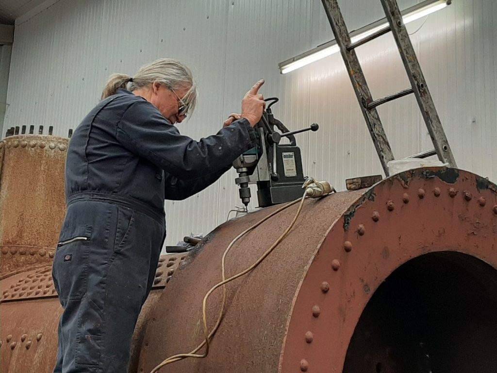 Ade drilling out smokebox rivets on Caliban's boiler