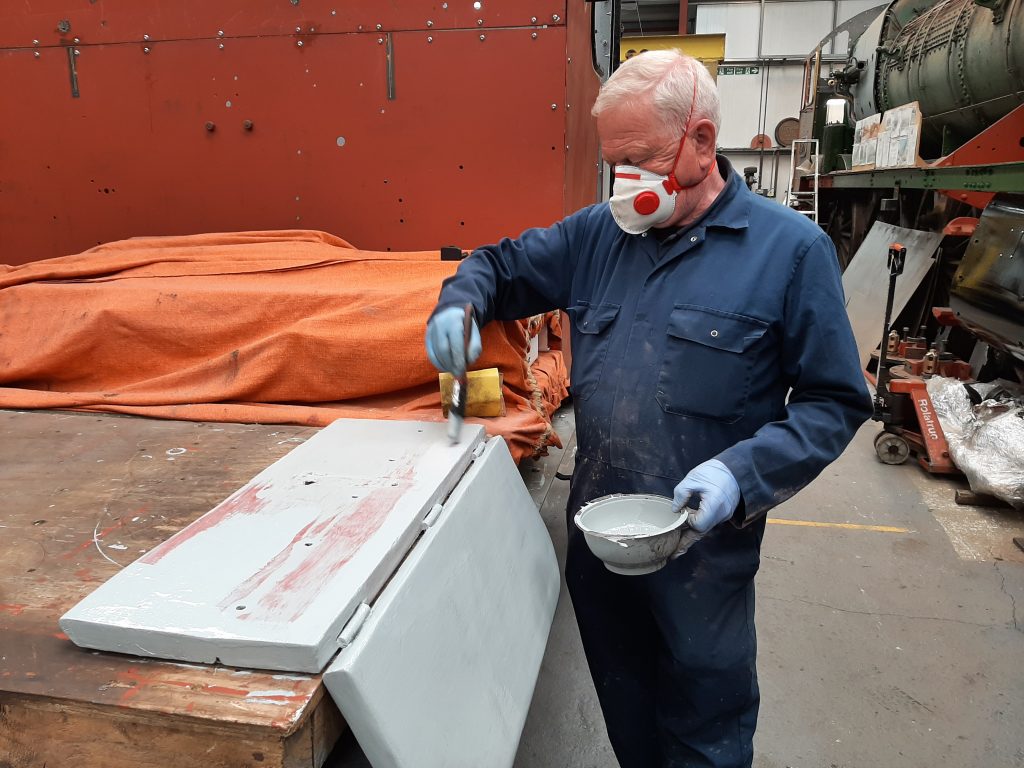 Paul Newton painting a seat from Fluff