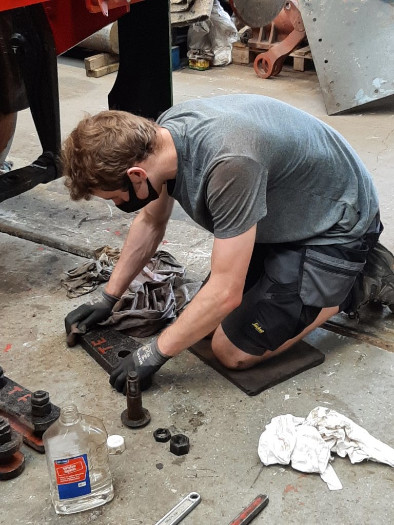 Sam cleaning Wootton Hall's tender brake linkage