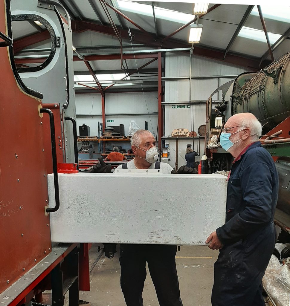 John Davis and Phil Bell loading Fluff's fuel tank into the cab